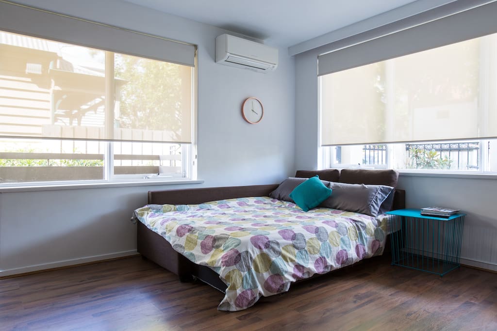 The couch converts to a double bed while not taking up the entire room.