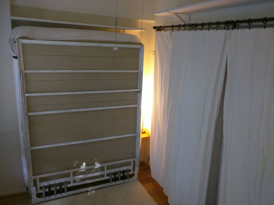 The Murphy bed, once folded up, allows for rolling out of two yoga mats onto the large white wool shaggy tufted rug which covers the width of the room.