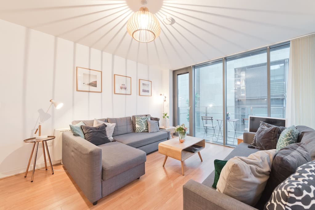 Living room area with designer furniture and view of balcony