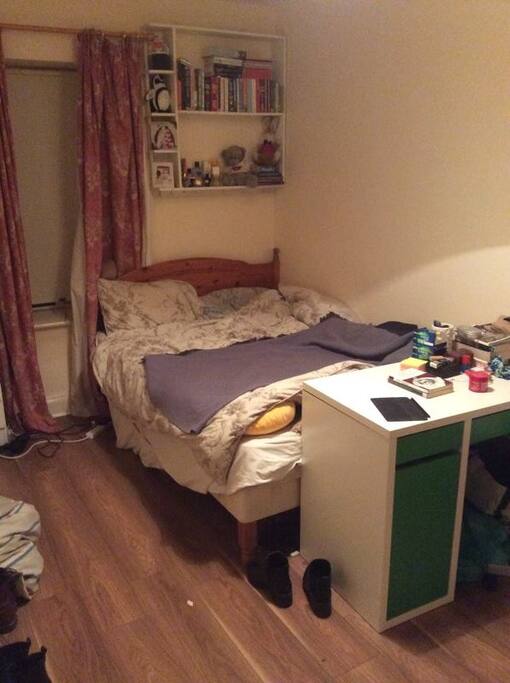 The bedroom has a really big bed and a lot of space to move around.