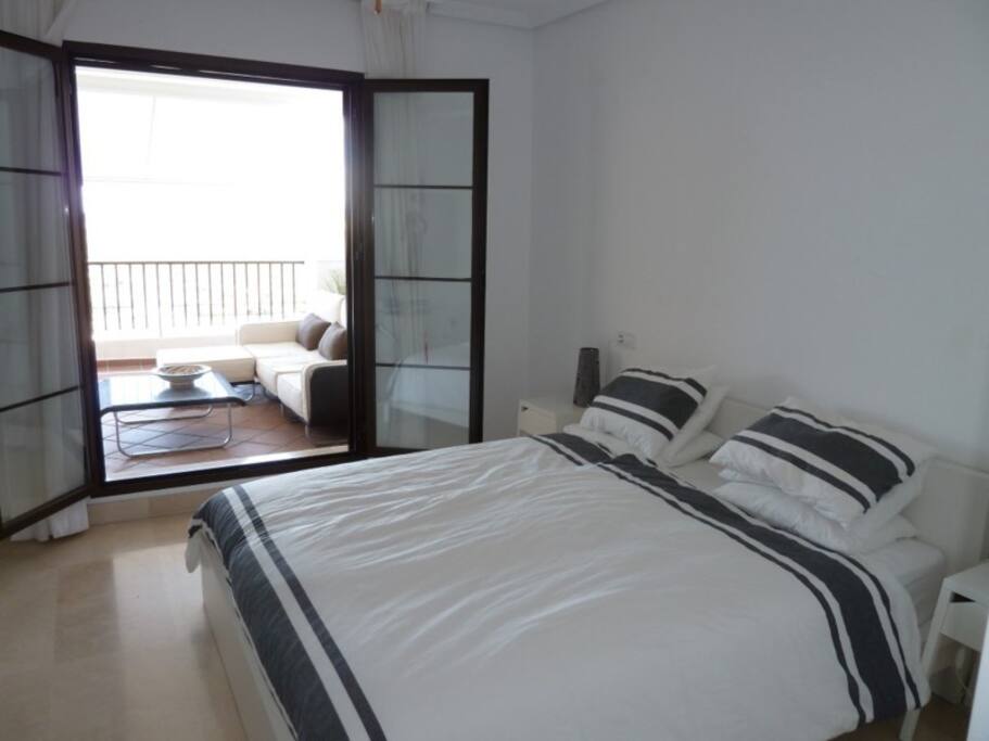Master bedroom with doors opening to terrace