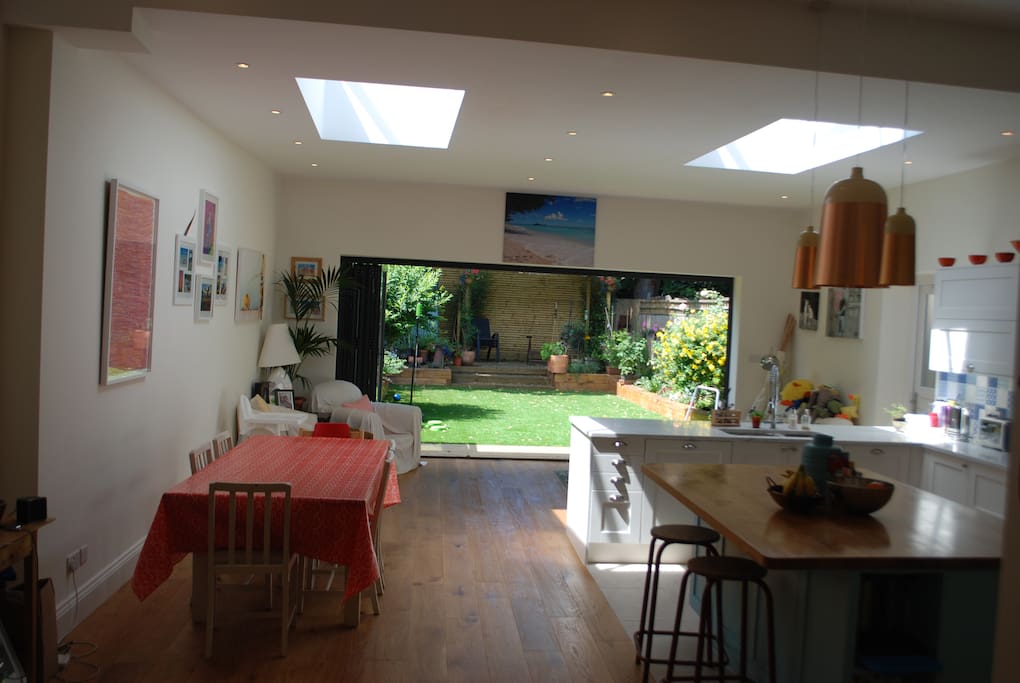 Massive open plan kitchen diner with bifold doors opening out onto the garden