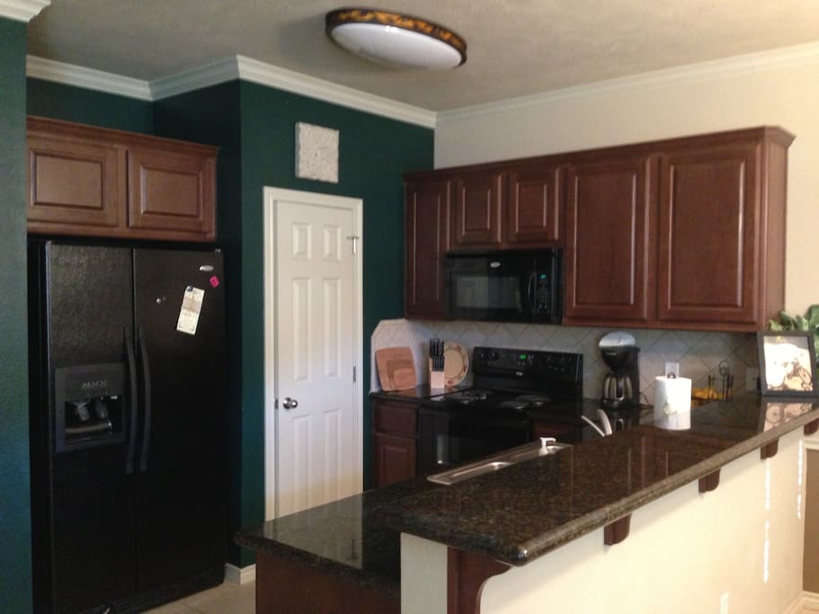 Spacious kitchen with all necessary appliances for cooking.