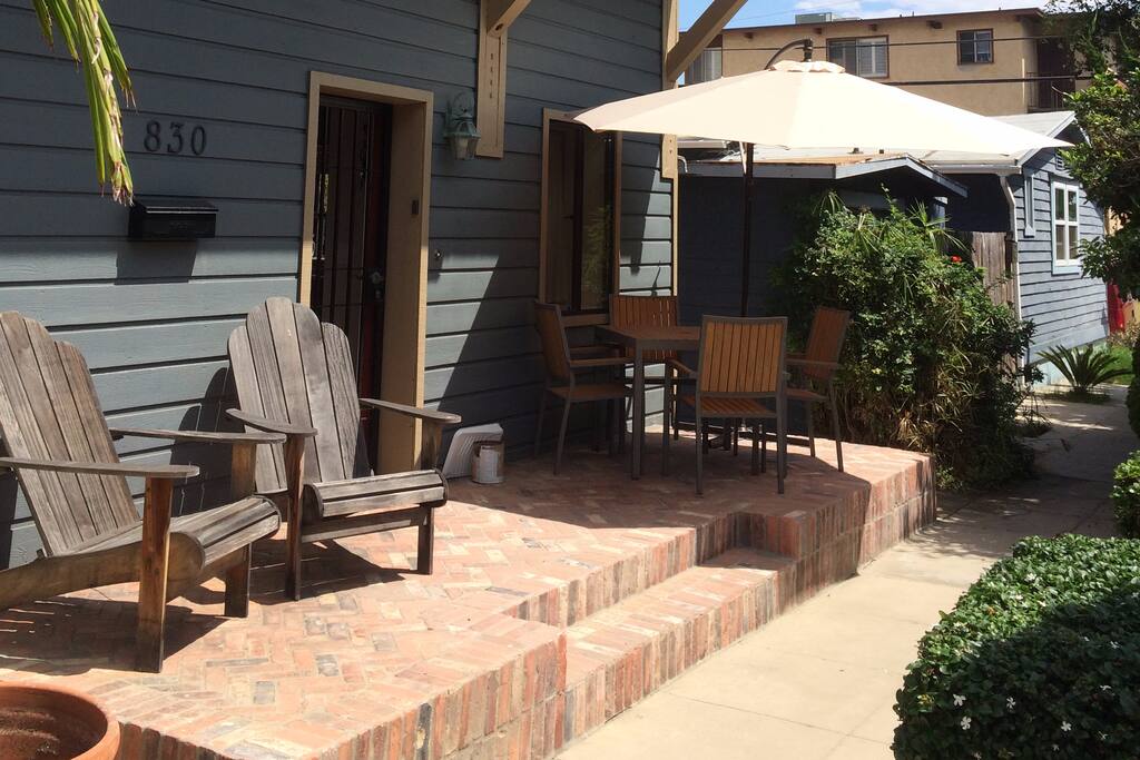 Front patio with dining table and chairs for 4 people. Cantilever umbrella for shade and 2 Adirondack chairs. This is where we usually bring out the grill. The window over the table opens into the kitchen.