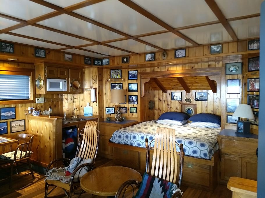 Inside the Captain's Cabin with a King size bed and rocking chairs.
