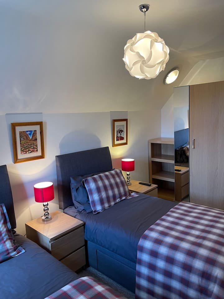 Bedroom 5 - 'Ramore' - Red checked twin room with smart TV 