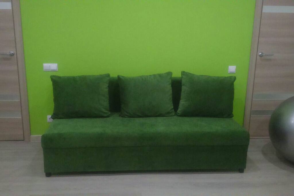 Studio-couch in the living room. Bedroom door on the left, storeroom door on the right