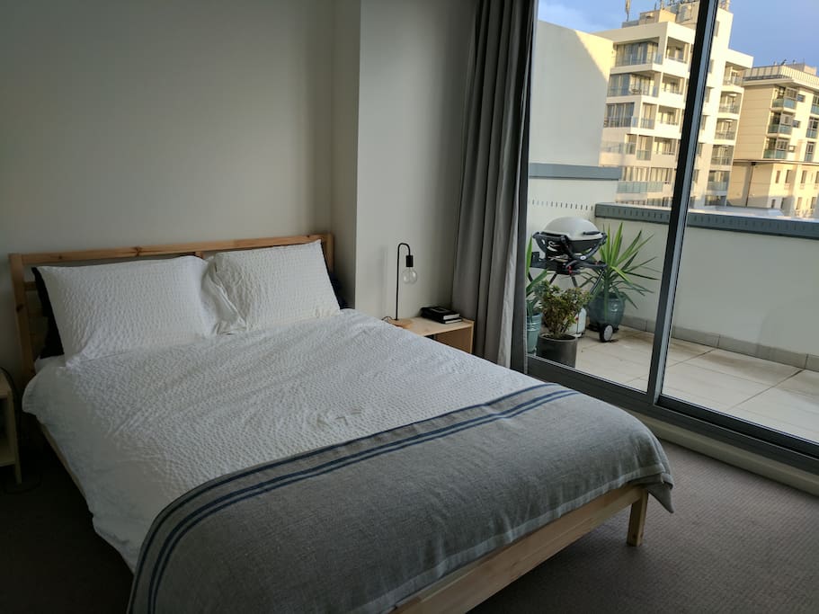 Bedroom with sliding glass doors onto the balcony
