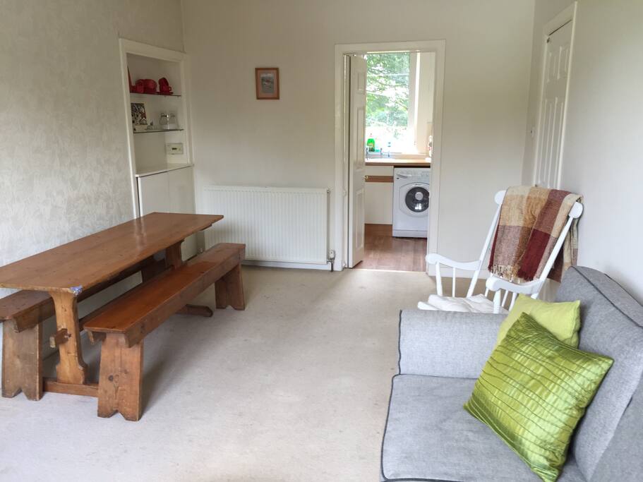 Living room showing dining table and doorway to kitchen