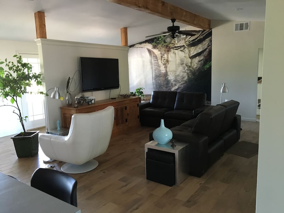 Open living room with reclining sofas and a 55" TV