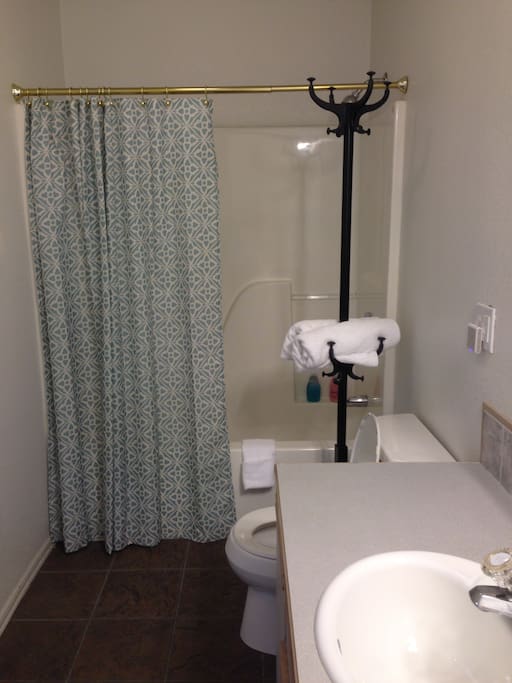 Comfortable bathroom with a bath tub and shower.