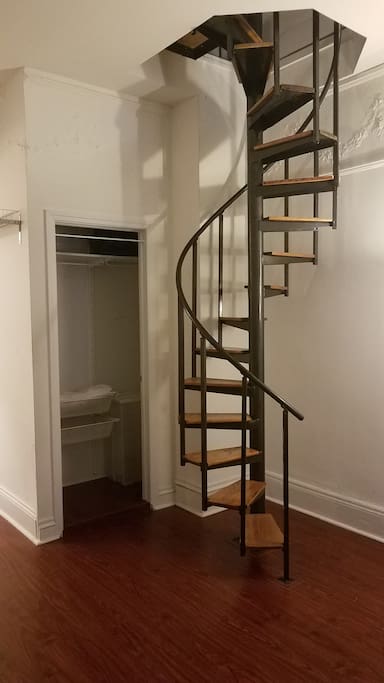 spiral stairwell from living room to bedroom
