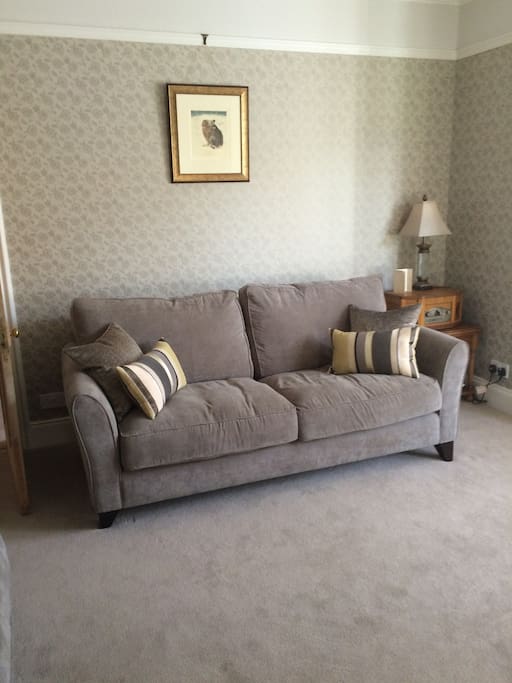 Comfortable settees add to the relaxing atmosphere of the sitting room