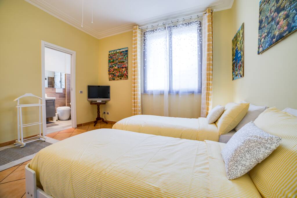 The twin beds and the large window