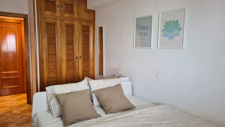 Bedroom 2: The bedroom has a built-in wardrobe, dresser, stool, and double bed 200x160 cm. There's a hanger on the door for hanging clothes or towels. The flush window faces the patio, so you have direct contact with the sea, the view of the waves, and you can hear the noise.