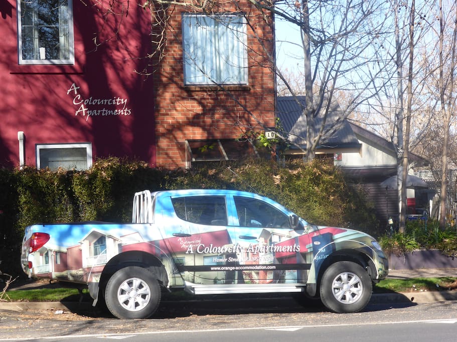 A Colourcity apartments courtesy vehicle outside The Lawson apartments building in winter