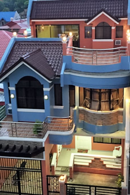 The room is on the second floor, the big window with the blue border looks out from that room.
