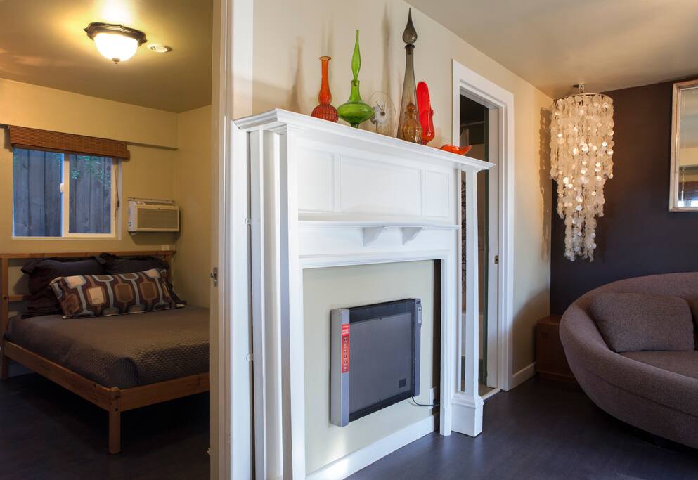 The heater inside the fireplace mantle and a bedroom view. Queen size memory foam bed with luxury linens.
