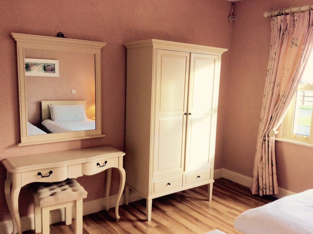 Cream furniture in twin bedroom