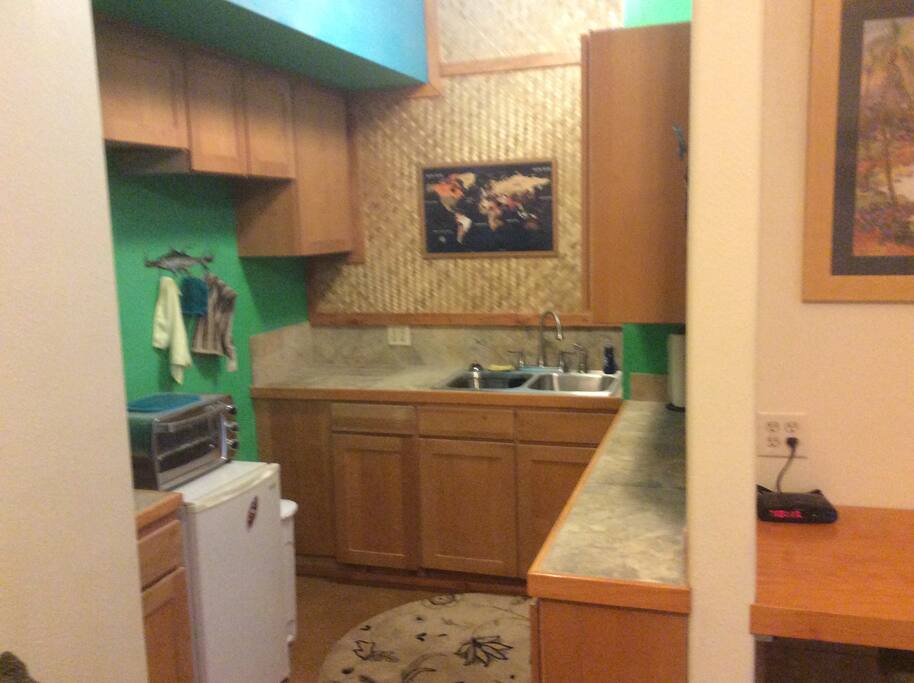 Kitchenette with double sink, mini fridge / freezer, microwave, coffee maker, and toaster!