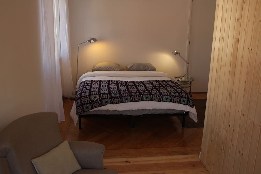 Very comfortable queen bed with a wardrobe on the right. View from the inner sitting room