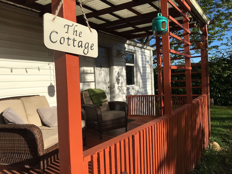 Back of the cottage faces a private fully enclosed yard with maple and walnut trees.