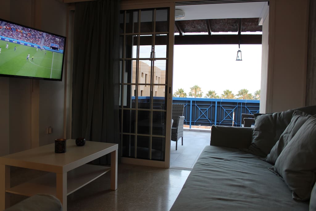 A confortable sitting room with a sofa/bed a couch and a 42" flat TV. The Sofa may be used as is, as an extra single bed, or opened to a spacious and confortable double bed (bedings available at the apartment)