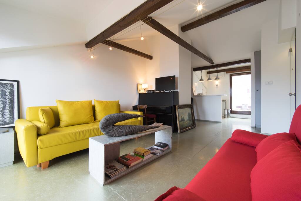 Living room with two pull-out sofas and the kitchen