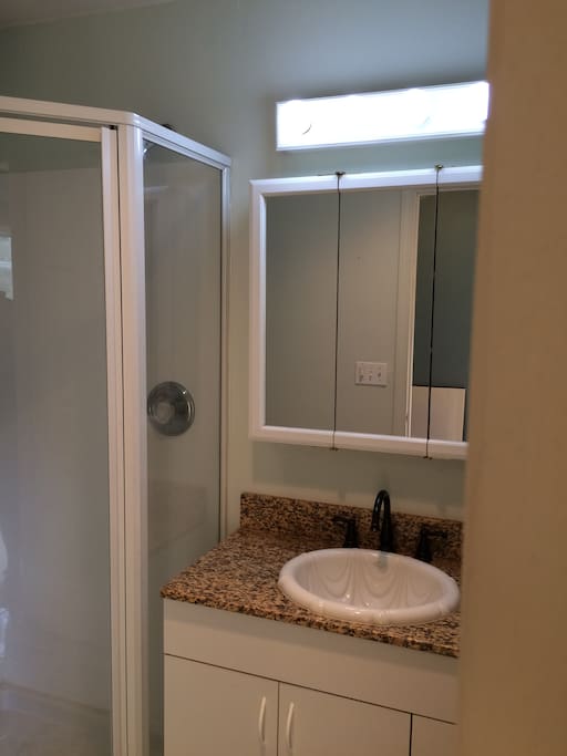 Bathroom with shower attached.