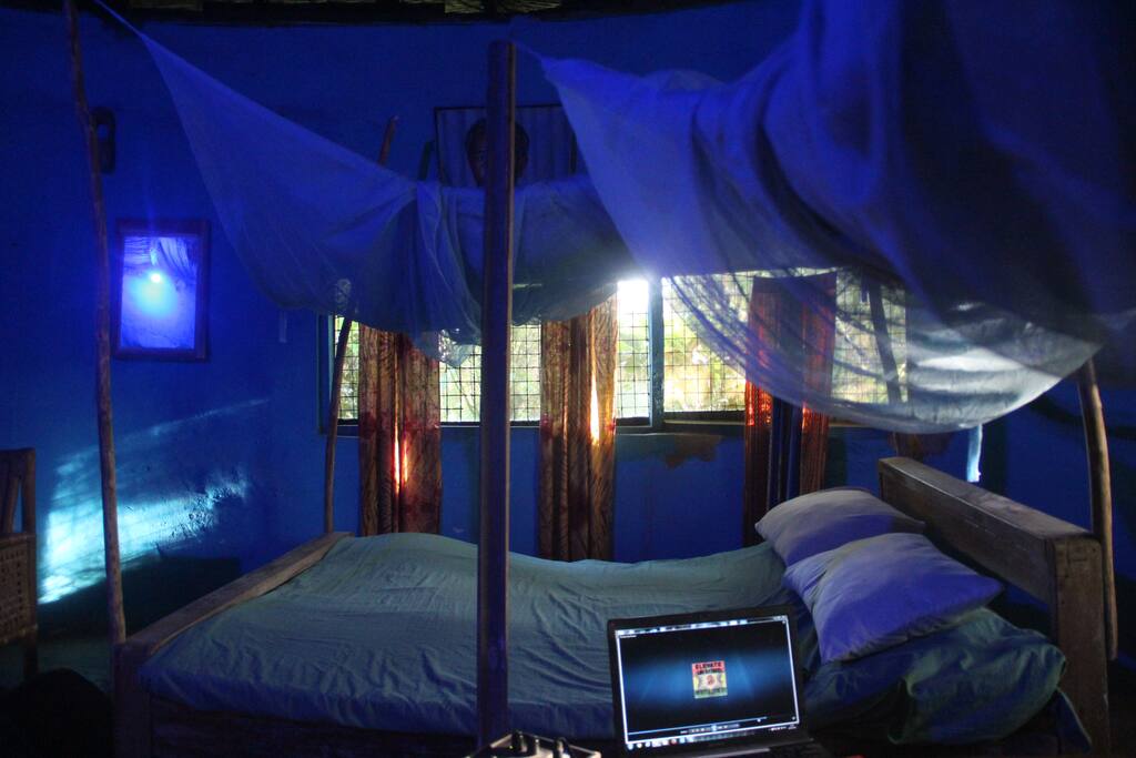 2 double beds in this cosy round conical clay room. Mosquito nets and fan and private bathroom. Can sleep 5 with extra mattress on the floor. Good for families or groups.