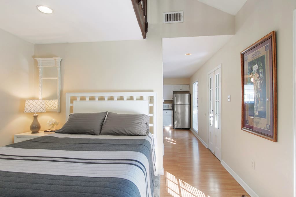 Comfortable Queen bedded bedroom with TV, cable, storage armoire and great natural light