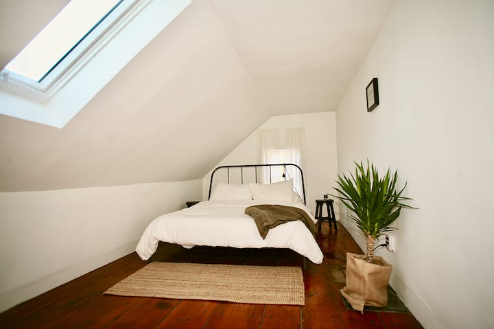 This is one of two smaller bedrooms with a queen-sized bed and a glorious skylight. Wake to the sunrise and the sound of the creek outside.