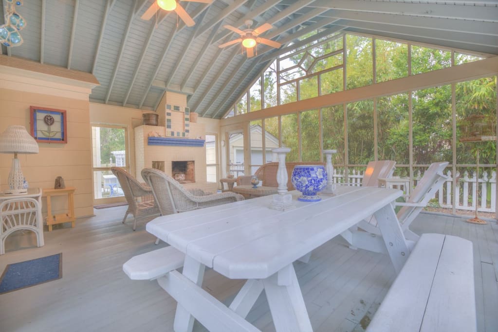 Large screened outdoor living room with comfortable seating for the whole guest list