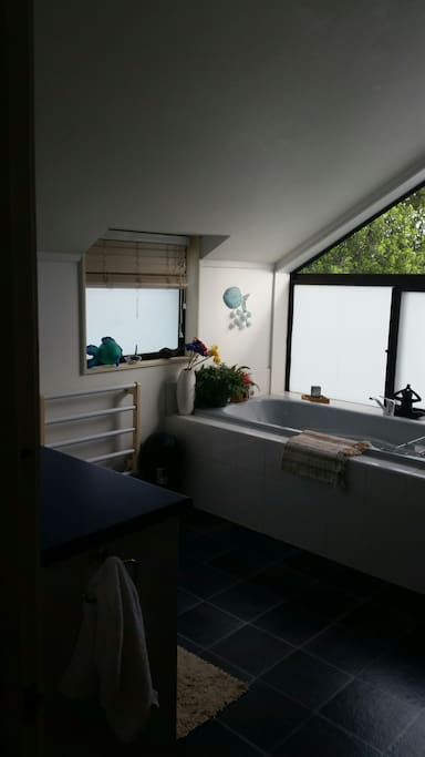 Shared bathroom with bath and shower