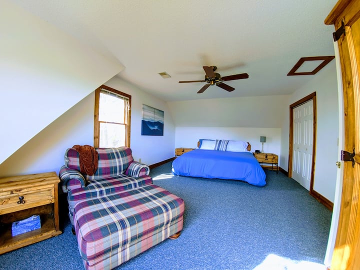 The Master bedroom boasts a large KING size bed with a sitting area and a 32" Roku TV. Relax while reading a book and enjoying the beautiful mountain scenery through the large picture window.