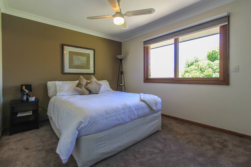 Beautiful Queen bedroom with quality linen and luxury pillows.