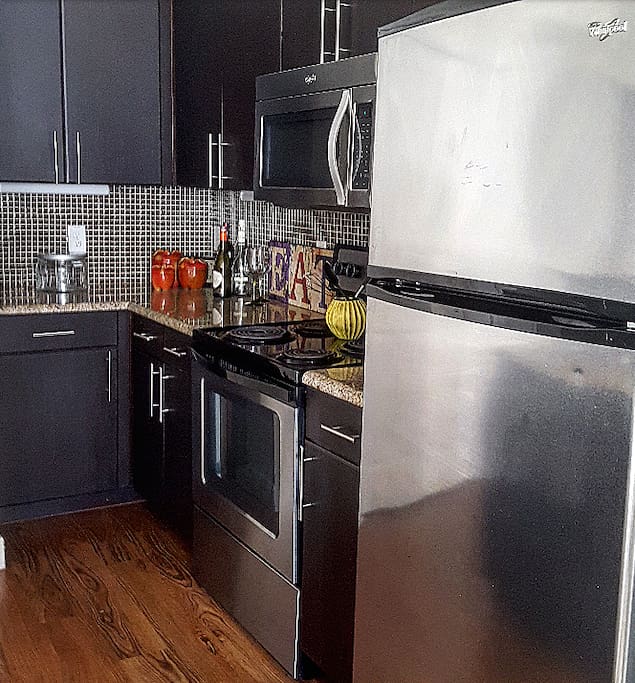 Custom kitchen cabinetry/granite countertops/whirlpool stainless steel appliances/urban living