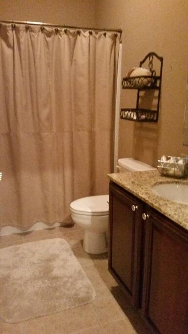 Our full bathroom offers a rub and shower, with ceramic tile flooring.