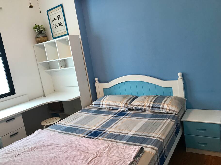 Queen size bed and desk in the room
房间里有双人床和书桌