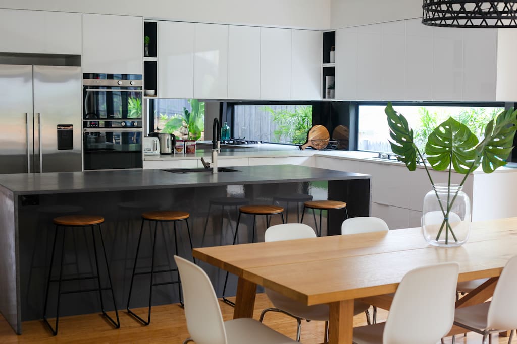Huge kitchen with Fisher & Paykl appliances and concrete benchtops