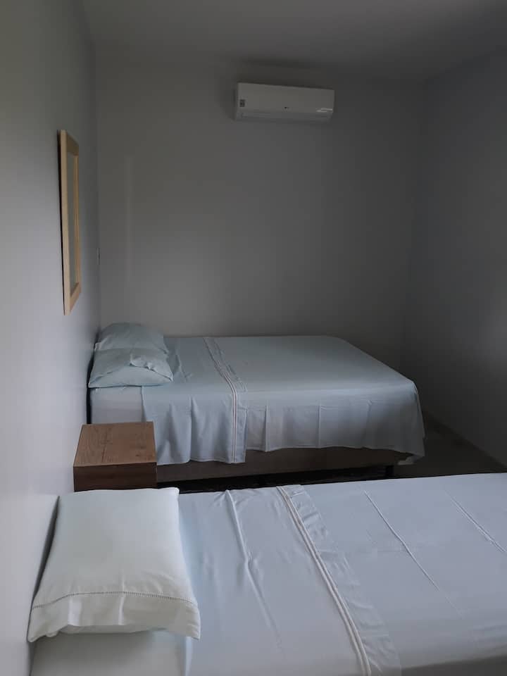Room 1, with a double bed and a single bed.