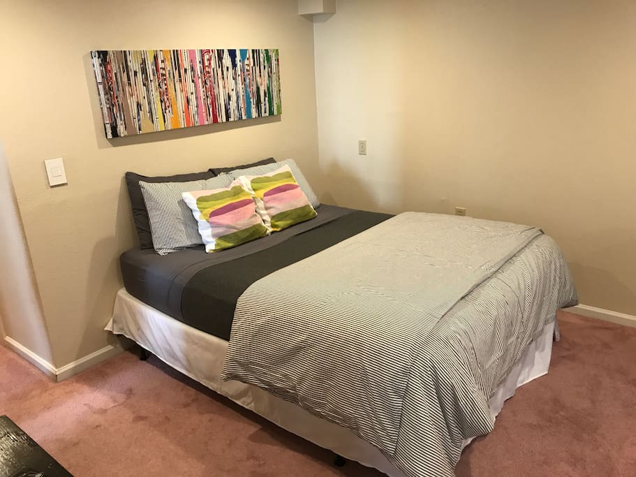 Queen bed in the bedroom adjacent to the living room