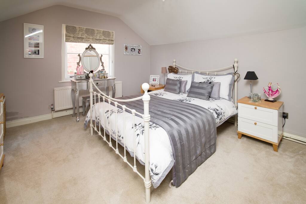 Upstairs double bedroom with wardrobe and drawers.