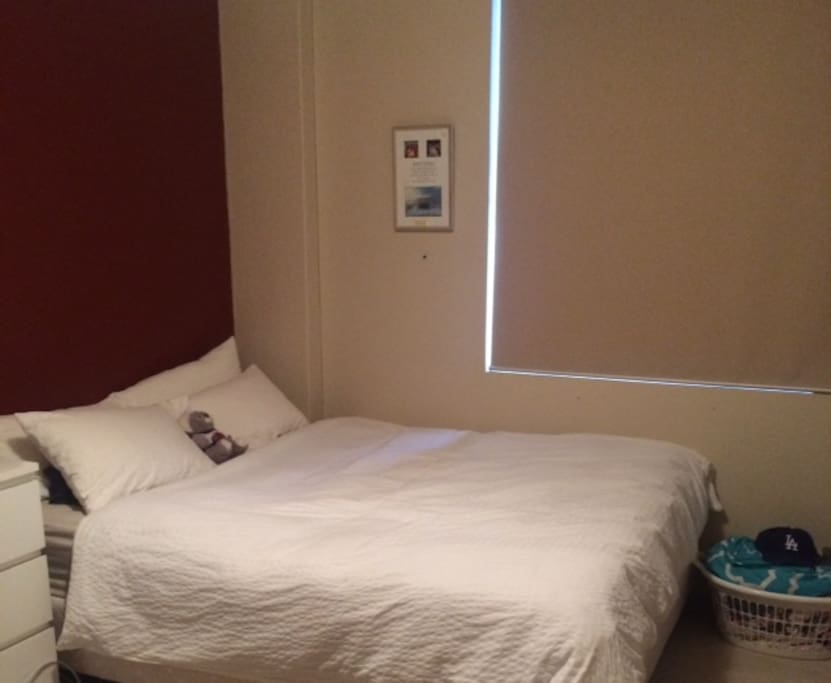 The very comfortable Queen bed - the blinds come up for sea views from your bedroom.