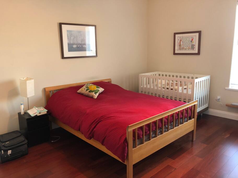 2nd bedroom with queen bed and crib