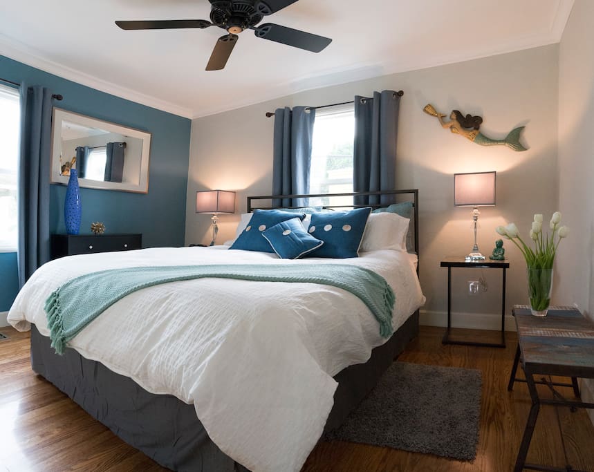 Blue Bedroom. Overhead fans, windows, closet, dresser, hardwood floors.