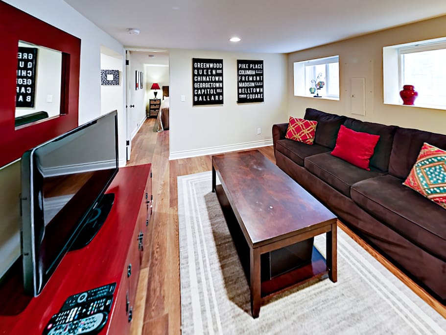 The living area is adorned with modern furnishings and regionally inspired artwork.