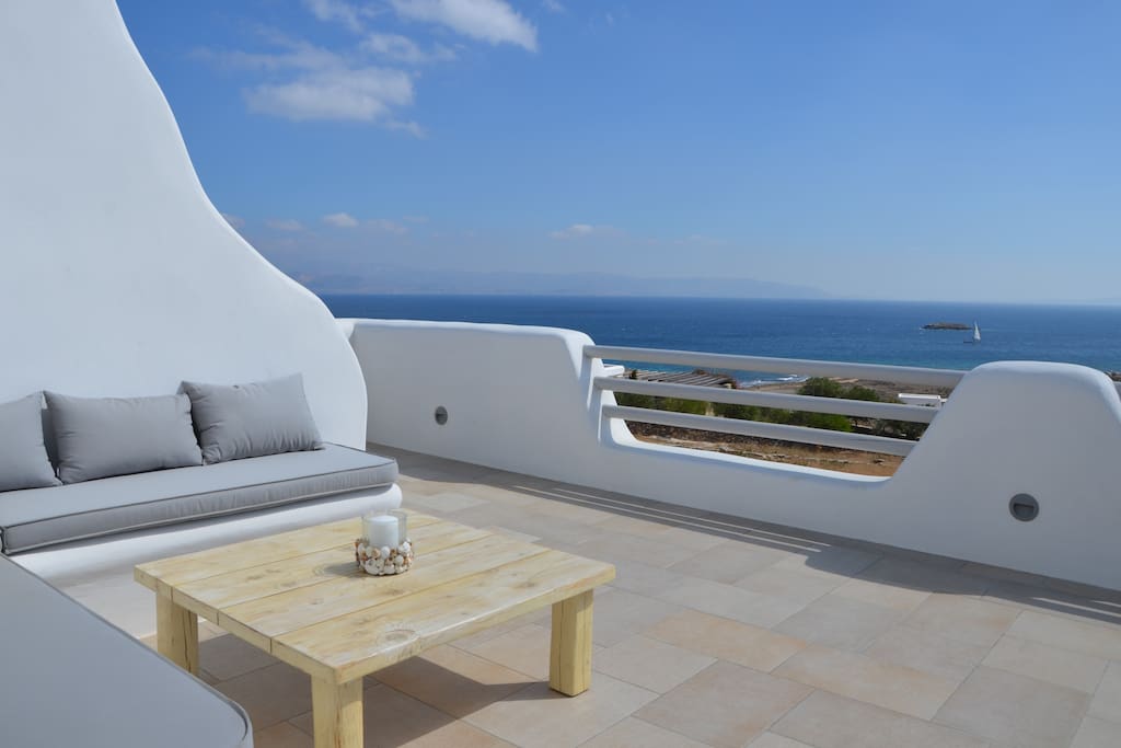 20m2 veranda in the 1st floor with a cozy sitting area, a panoramic sea view and a separate access to the garden via outdoor stairs