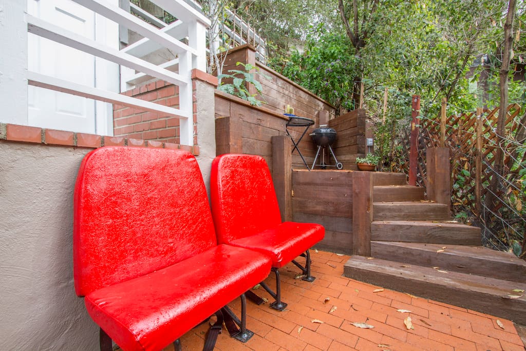 Outdoor patio balcony 1, with stairs leading to patio balcony 2. Revived bus seats give a bright, modern (& surprisingly comfortable) outdoor area to enjoy.