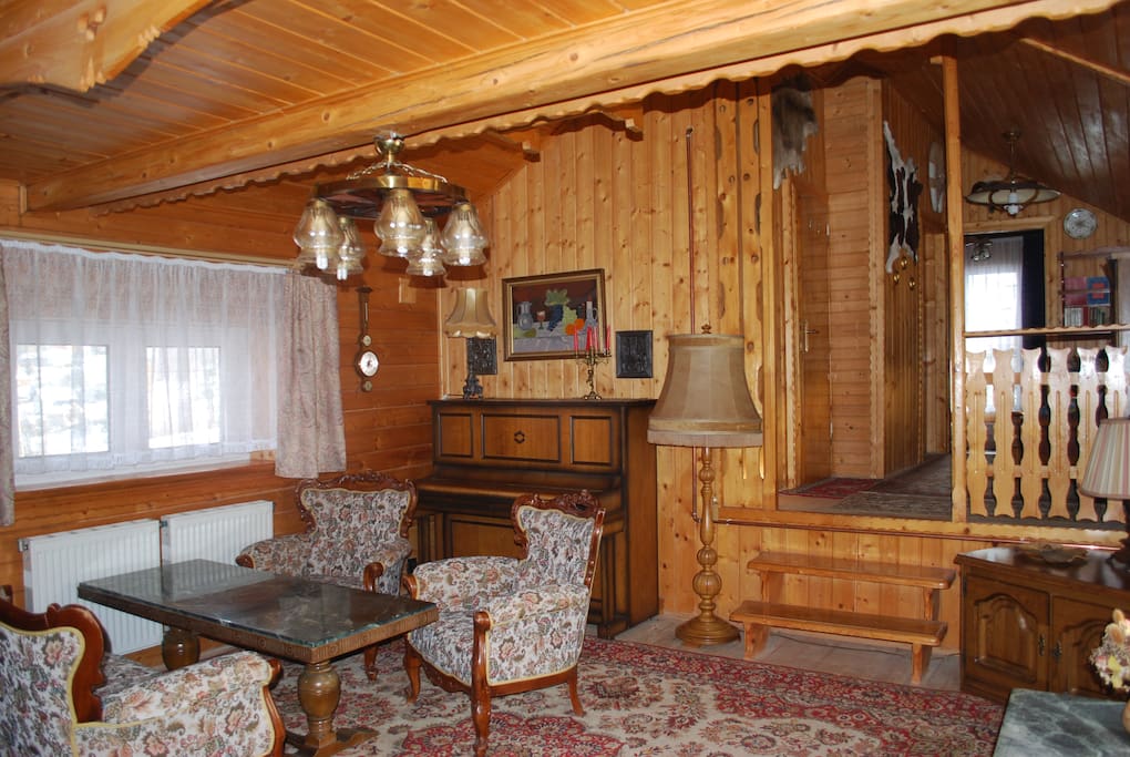 Stylowy salon z kominkiem i pianinem.
